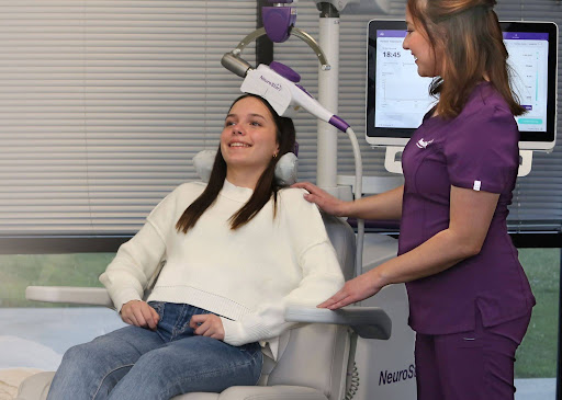 What does TMS treatment do? A smiling adolescent receives NeuroStar TMS Therapy from a clinical technician.