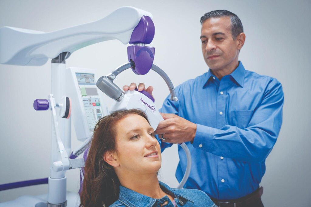 Patient receiving a treatment session using the NeuroStar transcranial magnetic stimulation device.